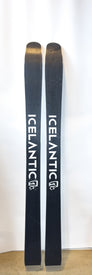 A pair of black Demo - 23/24 Mystic 97 skis by Icelantic, standing upright against a white background, with the brand name and logo visible on both lightweight skis designed for women's backcountry touring.