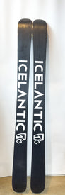 A pair of black Icelantic Demo - 23/24 Nomad 105 skis featuring the white ICELANTIC logo and a stylized mountain graphic, standing upright against a white background—these freeride skis are built for adventure.
