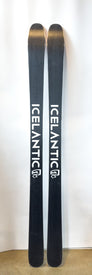 A pair of Demo - 23/24 Pioneer 86 skis by Icelantic stands upright against a white background, featuring the bold ICELANTIC branding on each ski. Expertly handmade in Colorado, these all-mountain skis deliver exceptional quality and performance.