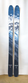 A pair of Demo - 23/24 Pioneer 96 all-mountain skis by Icelantic, featuring blue tones with mountain and geometric designs, are shown standing upright against a white background. The model name “Pioneer 96” and brand “Icelantic” are labeled near the bottom.