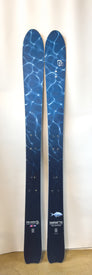 A pair of Icelantic Demo - 23/24 Shaman 2.0 110 skis, featuring a blue water ripple pattern, standing upright against a plain white background.