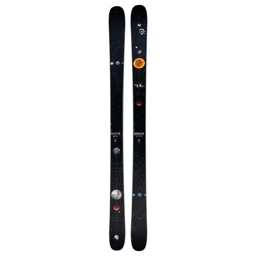 The Icelantic Skis Nomad 94 is a pair of black skis adorned with a solar system design, showcasing planets, the sun, and orbital paths on a starry backdrop.