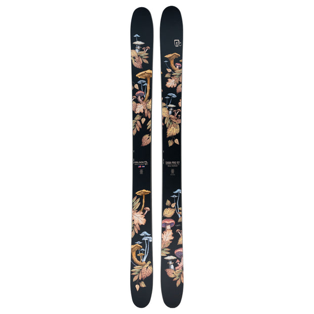 A pair of Icelantic Saba Pro 117 big-mountain skis, handmade in Colorado, featuring detailed illustrations of various mushrooms and leaves in earthy tones arranged along the length of each black ski.