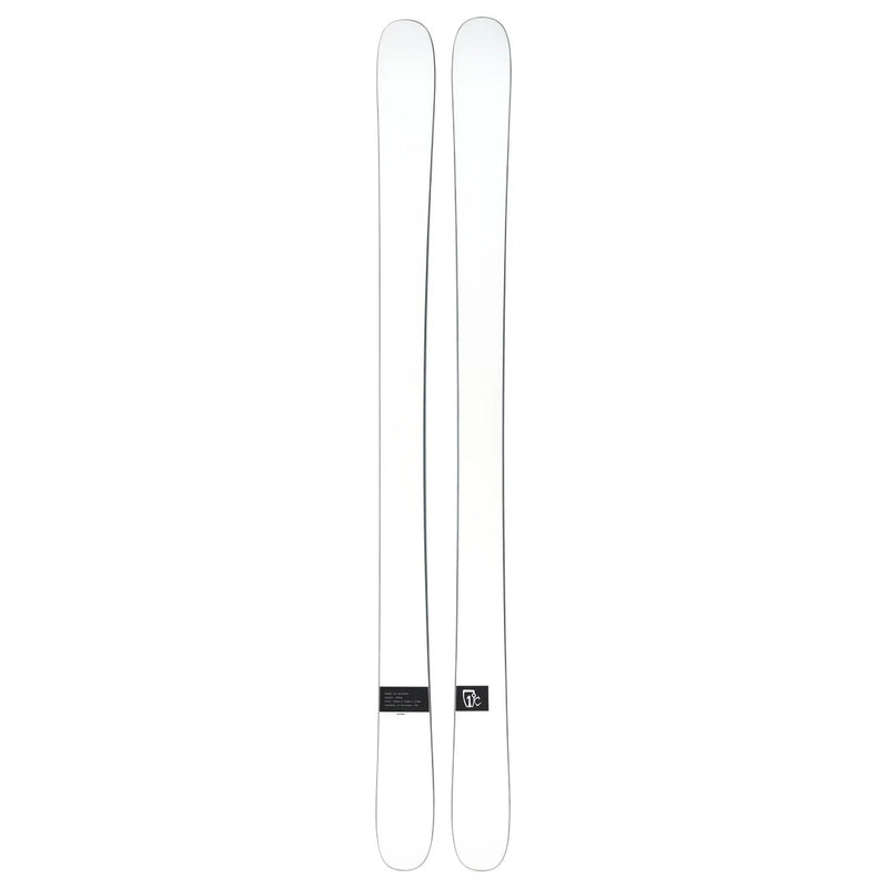 A pair of Icelantic Skis Nomad 100 Whiteout are placed side by side on a plain background, featuring minimal markings and a small logo near the base of one ski.