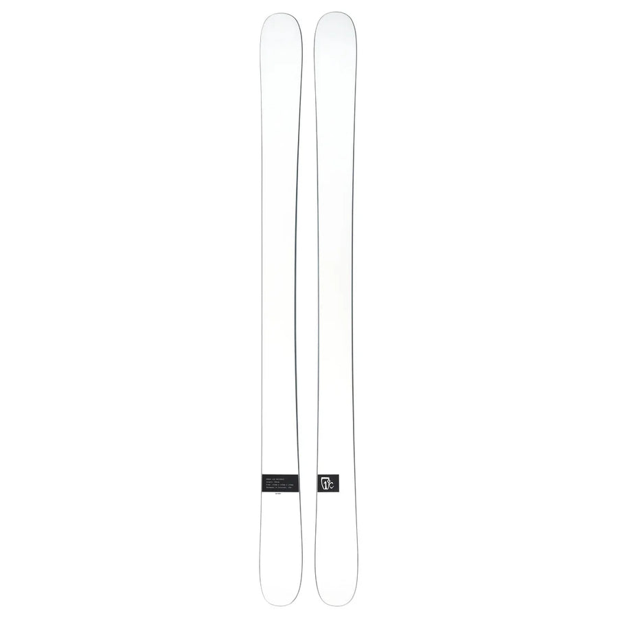 A pair of Icelantic Skis Nomad 106 Whiteout skis in white with a minimal design, displayed side by side, featuring a small black label with text and the brand logo near the base.