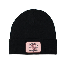 Introducing the Cowgirl Ski Club Beanie - Black by Icelantic Skis: this tightly knit black beanie features a folded brim and a custom rectangular pink patch reading "Official Shred Club 2024 Icelantic Skis," along with a graphic of a bird holding skis—perfect for any Cowgirl Ski Club member.