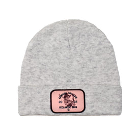 A white heather knit beanie with a folded brim from Icelantic Skis, featuring a custom patch with a graphic of a skier and the text "Original Shkuski, Icelandic Skis, 2020"—the perfect accessory for any Cowgirl Ski Club member.