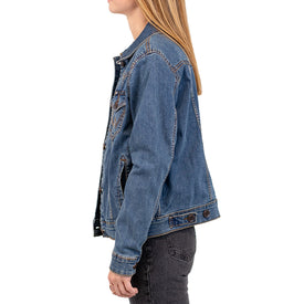 A person with long blonde hair is shown in profile, facing left, against a white background, wearing an Icelantic Skis Wrangler Cactus Denim Jacket - Women's and black jeans.