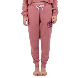 A person stands barefoot with hands at their sides, wearing Icelantic Skis’ Cowgirl Ski Club Joggers in pink with a white drawstring and the matching cropped sweatshirt—a cozy, relaxed look that’s perfect for lounging or showing off your Cowgirl Ski Club pride.