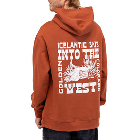 A person wearing the rust-colored Icelantic Skis Mezcal Skull Hoodie, featuring a white graphic on the back with the text "Icelantic Skis Into the West Golden Colorado," along with an animal skull and desert plants. This unisex oversized hoodie is crafted from recycled polyester, offering both comfort and sustainability.