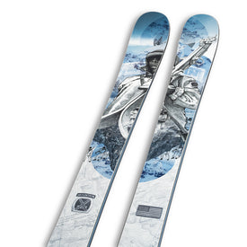 A pair of limited edition Icelantic Skis 10th Mtn Nomad 100 skis featuring a blue and white design with an intricate illustration of a person in winter gear holding skis, mountain scenery in the background, and patches—including an American flag—near the bottom, from the exclusive NOMAD 100 10th Mountain ski collection.