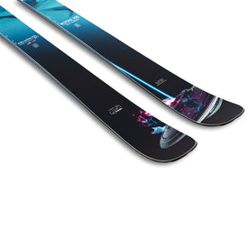 A pair of J Skis x Icey Nomad 106 freeride skis by Icelantic Skis, showcasing futuristic graphic designs with neon accents and abstract shapes in black and blue, displayed on a white background.