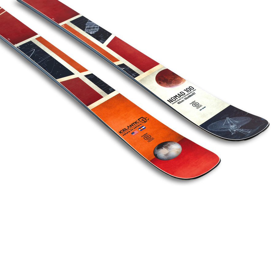 Two vibrant Icelantic Skis Nomad 100 skis with geometric red, orange, and white patterns and space-themed graphics are displayed on a white background.