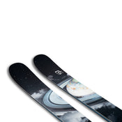 The Icelantic Skis Nomad 106 is a pair of black skis adorned with a cosmic space theme, featuring stars, planets, and Saturn’s rings.