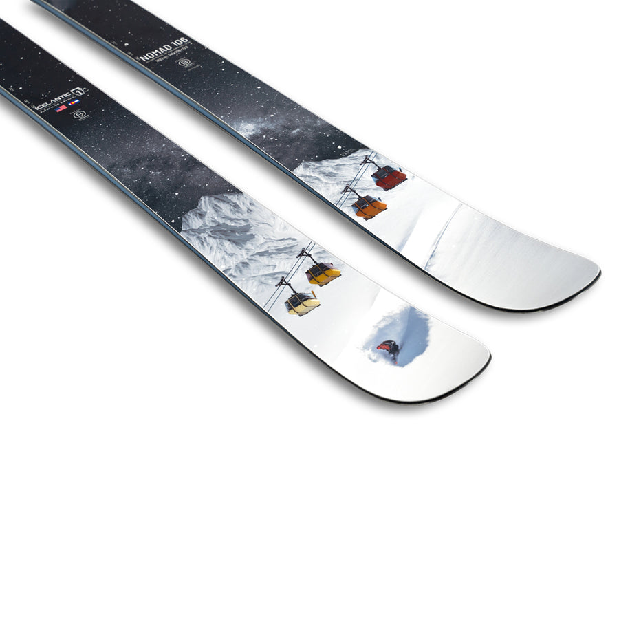 The Icelantic Skis Nomad 106 features a design with snowy mountains, colorful ski lifts, and a skier gliding across white snow under a starry night sky.
