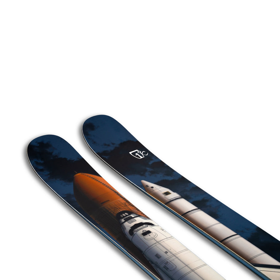 The Icelantic Skis Nomad 112 features detailed artwork depicting a space shuttle launch, complete with the shuttle, boosters, and dark clouds in the background.