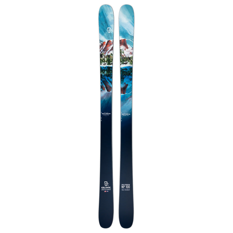 The Icelantic Skis Rocky Mtn NP 100 is a pair of all-mountain skis handmade in Colorado, featuring a striking blue and white mountain landscape graphic with snowy peaks, trees, and a logo near the tips for exceptional quality and performance.