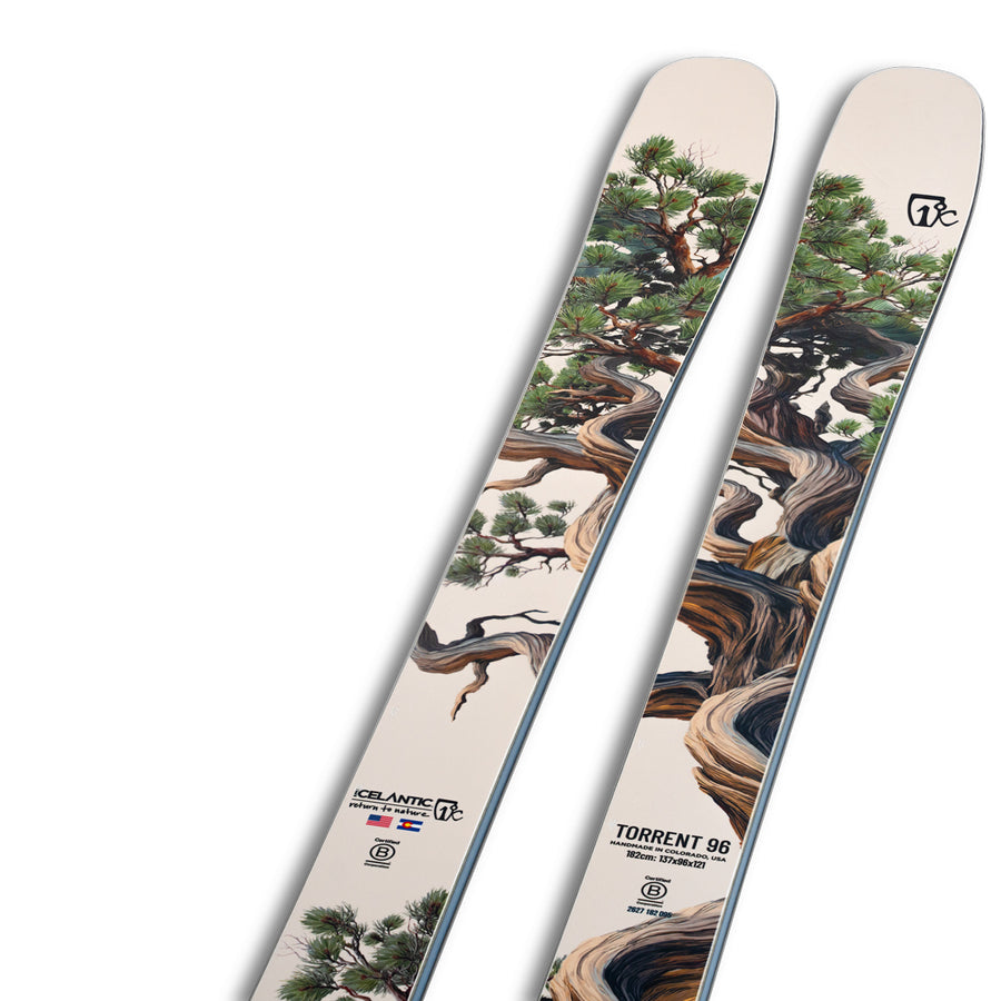 A pair of Icelantic Skis Torrent 96 all-mountain skis, showcasing artwork of a twisted, detailed tree with green foliage on a light background. These carbon-reinforced skis are labeled “Torrent 96” and display the Icelantic Skis logos near the base.