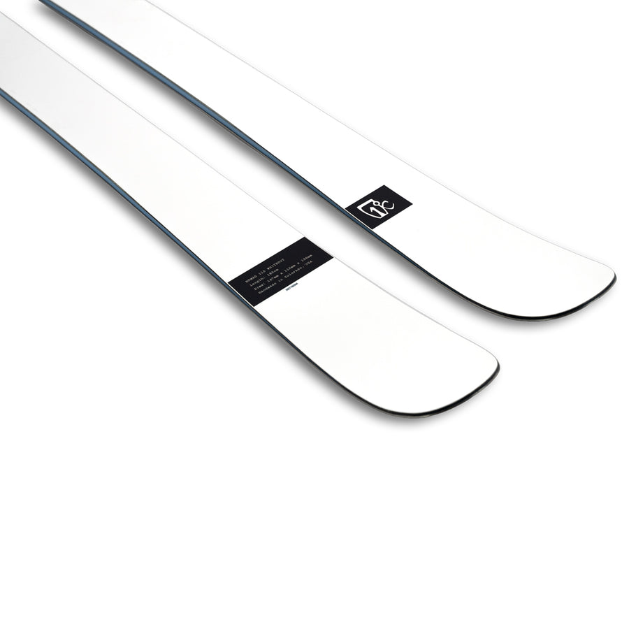 A pair of Icelantic Skis Nomad 112 Whiteout powder skis in white with black edges and a small black rectangular logo near the tips, displayed against a white background—perfect for advanced skiers pursuing top-tier freeride performance.