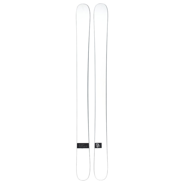 A pair of Icelantic Skis Nomad 112 Whiteout freeride skis, featuring a plain white design with a small black rectangular label near the tail on one ski, shown side by side on a white background.