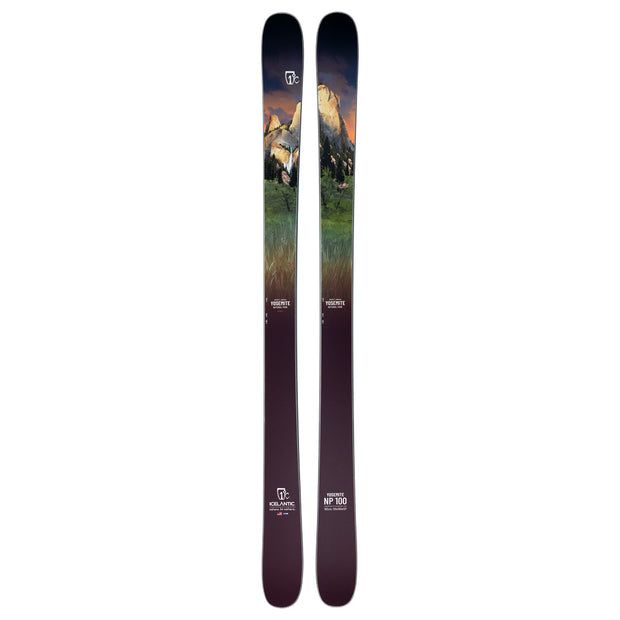 A pair of Icelantic Skis Yosemite NP 100 all-mountain skis, handmade in Colorado, featuring a scenic landscape graphic with mountains, green trees, and a sunset sky. The skis transition from a dark base to lighter tones toward the top, with logos and model information displayed near the bottom.