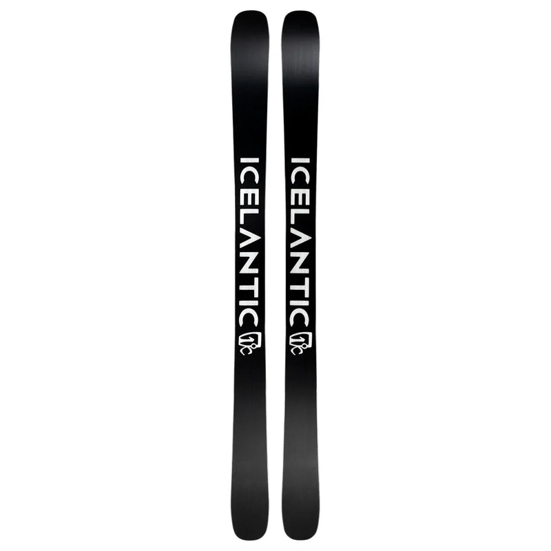 A pair of Icelantic Skis Torrent 102, featuring a black base with the white word “ICELANTIC” and its logo printed vertically along each ski. The skis are displayed side by side, highlighting their bases.