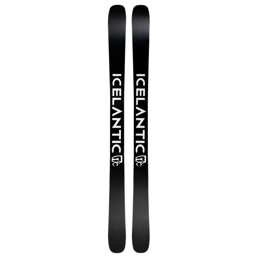 A pair of Icelantic Skis Torrent 102, featuring a black base with the white word “ICELANTIC” and its logo printed vertically along each ski. The skis are displayed side by side, highlighting their bases.