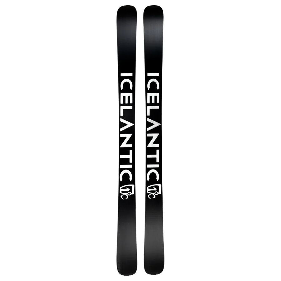 A pair of Icelantic Skis Nomad 106 Whiteout, featuring a black design with bold white “ICELANTIC” lettering and a white logo near the tips, displayed side by side on a white background.