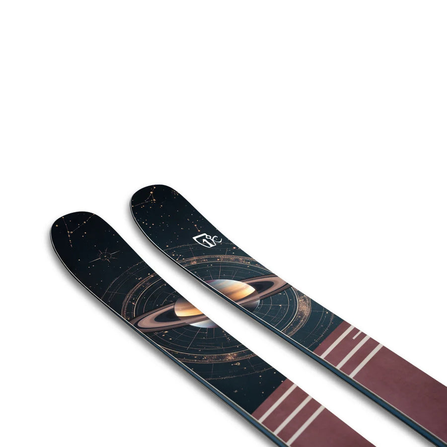 The Icelantic Skis Maiden 94 features artwork of Saturn and cosmic designs on a dark background, accented with maroon and white stripes near the tips.