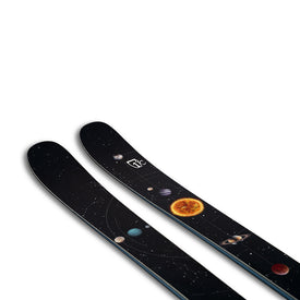The Icelantic Skis Nomad 94 is a pair of black skis adorned with a space-themed design that features planets, stars, and the sun set against a white background.