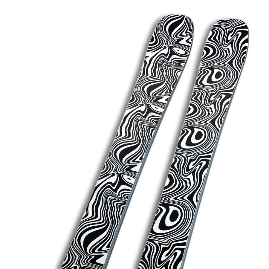Two Icelantic Skis Torrent 96 Proto skis with a black and white optical illusion pattern featuring wavy, swirling lines on their tops, set against a white background.