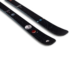 The Icelantic Skis Nomad 94 is a pair of black skis adorned with a space-themed design featuring planets, the moon, and stars scattered along the top surface.