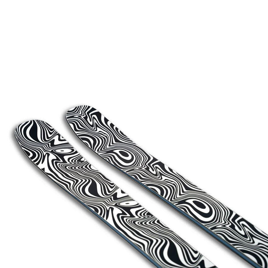 Two Icelantic Skis Torrent 96 Proto skis, featuring a bold black and white abstract swirl pattern on their topsheets, are photographed against a white background.
