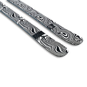 A pair of Icelantic Skis Torrent 96 Proto are placed side by side on a white background, featuring a black and white abstract wavy pattern that creates an optical illusion effect.