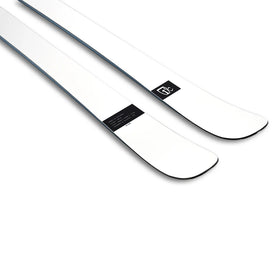A pair of Icelantic Skis Nomad 100 Whiteout, featuring a sleek white design with black edges and a small black logo near the tips, photographed on a white background.
