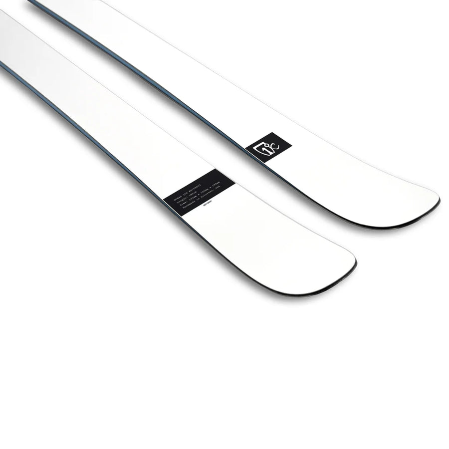 A pair of Icelantic Skis Nomad 106 Whiteout skis, featuring white topsheets with black rectangular logos and text near the tips, displayed against a white background.