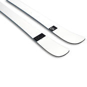 A pair of Icelantic Skis Nomad 94 Whiteout skis in white are shown side by side, featuring slightly upturned tips and a small black label with white text and logo near the front.