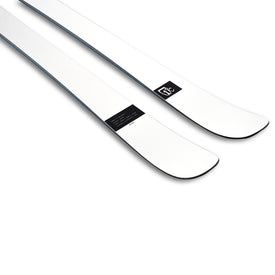 A pair of Icelantic Skis Nomad 94 Whiteout skis in white are shown side by side, featuring slightly upturned tips and a small black label with white text and logo near the front.