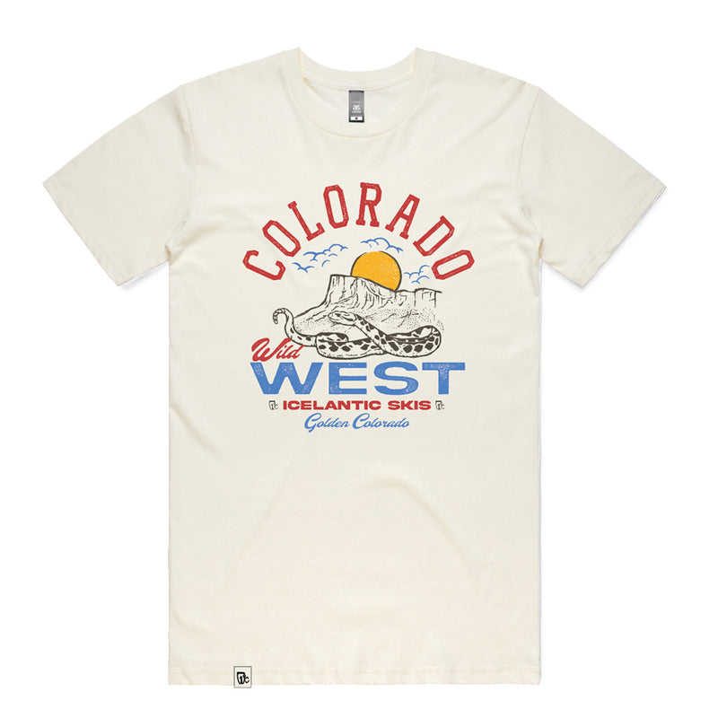 Introducing the CO Wild West Tee by Icelantic—a cream-colored T-shirt featuring a bold graphic of a snake, mountains, sun, and birds. The design includes the text “Colorado Wild West Icelantic Skis Golden, Colorado” in vibrant red, blue, and yellow tones. Made from 100% combed cotton in a regular fit for maximum comfort, this tee is part of our Into the West summer tees collection.