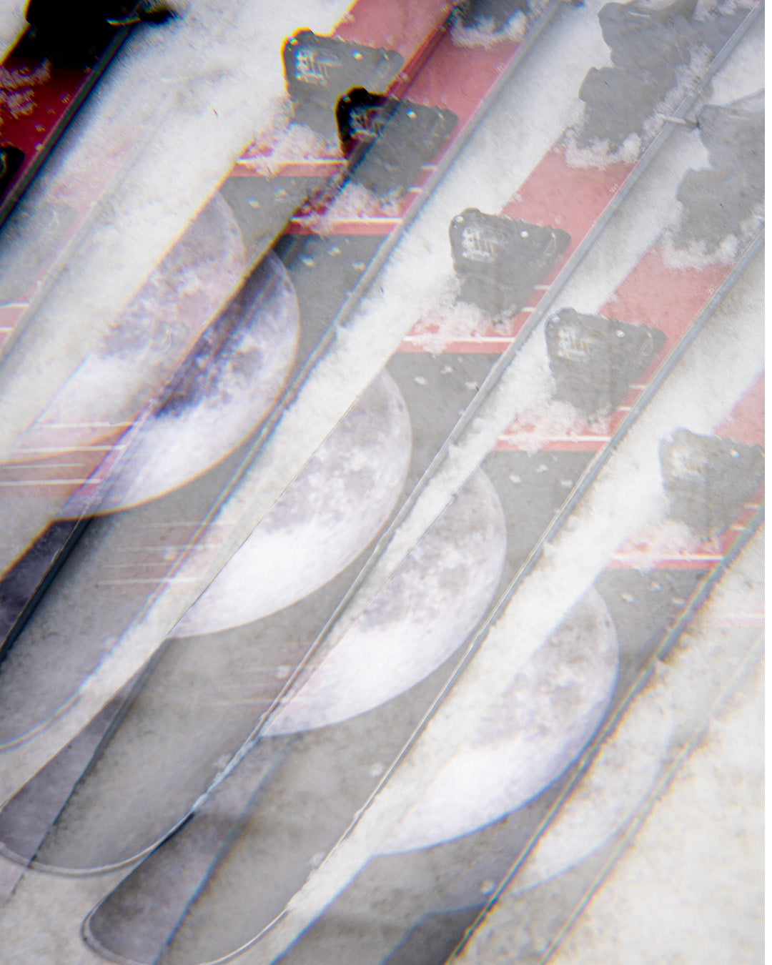 A blurred, duplicated image featuring repeated patterns of the moon and dark silhouettes on a reddish background, creating a layered, abstract effect.