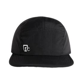 The Icelantic Skis Camp Cap - Black is a lightweight, five-panel running hat featuring breathable comfort for active days. It comes in black with a small white stylized "TC" logo on the front left side, visible stitching, and a slightly curved brim.