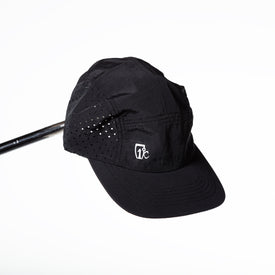 The Icelantic Skis Camp Cap in black features small ventilation holes on the sides and a white Icelantic logo on the front, shown here against a plain white background.