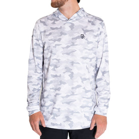 A person stands against a white background wearing the Icelantic UV Sun Hoodie in Snow Camo, a light gray and white camo-patterned long-sleeve featuring a small black logo on the left chest, quick-dry fabric, and UPF 50 sun protection.