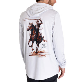 A person wearing the Icelantic UV Sun Hoodie - Cowboy, a white sun-protective shirt featuring a graphic of a cowboy riding a rearing horse and holding a lasso, with the text INTO THE WEST. This quick-dry hoodie offers UPF 50 sun protection, making it ideal for adventures under the open sky.