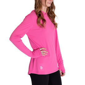 A woman stands sideways with one hand on her hip, wearing the Icelantic Womens UV Sun Hoodie in Hot Pink—a bright, long-sleeve sun-protective hoodie with thumb holes and UPF 50 for enhanced protection—paired with black leggings against a white background.