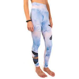 A person is shown wearing high-waisted 23/24 Soaring Kestrel Leggings by Icelantic, featuring a blue cloud pattern with black bird designs and crafted from Hyper Wiking WIKMAX Fabric, standing barefoot against a white background. Their head and feet are not visible.