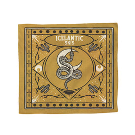 Introducing the Rattlesnake Bandana by Icelantic Skis—a lightweight cotton accessory made in Denver. This gold bandana features a striking coiled snake at its center, surrounded by geometric designs, moon motifs, and bold “ICELANTIC SKIS” text at the top. Decorative white and black accents complete the unique look.