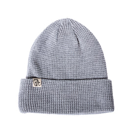 The Icelantic One Degree Waffle Beanie in Heather Grey is crafted from recycled polyester and features a folded brim with a small rectangular tag bearing a black logo on the left side. The beanie is displayed against a white background.