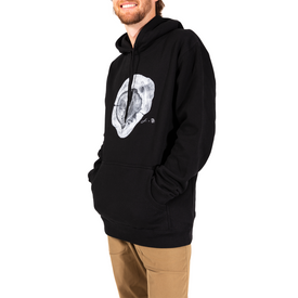 A smiling person wears the Icelantic Yew Lineage Hoodie, featuring a gray oyster graphic on the front, with hands in the hoodie pocket and tan pants, set against a white background.