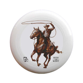 A white Cowboy Frisbee by Icelantic Skis showcases Travis Parr’s distinctive artwork of a cowboy on horseback swinging a lasso, with "INTO THE WEST" printed below the image and a small logo to the left.